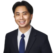 Tony Nguyen, UX Designer at Enkelwebb, smiling in a professional suit against a neutral background.